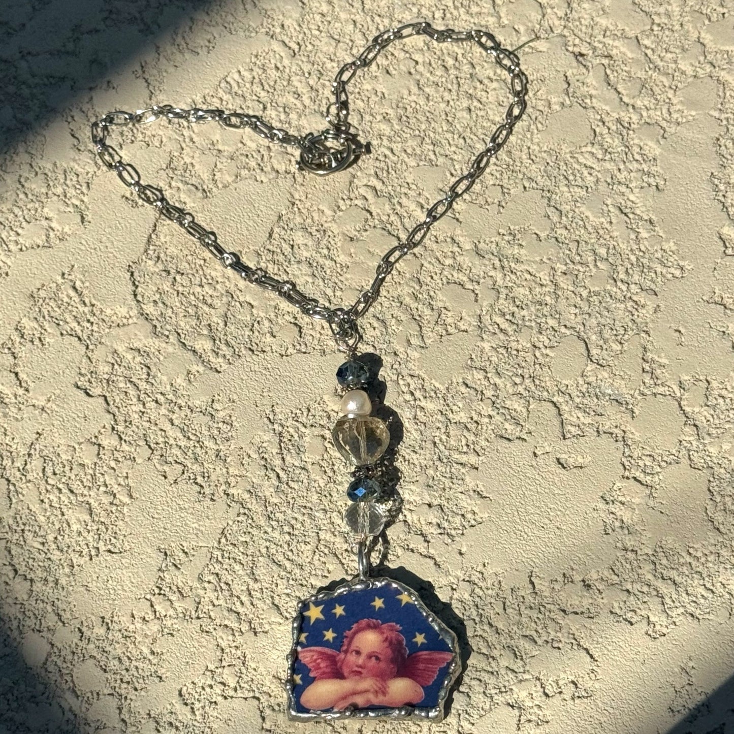 Cherub Broken China Pendant Caged in Silver Blend Bezel & Crystal Beads